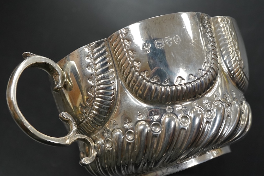 A late Victorian silver twin handled porringer in ealry 18th century style hanlded to handle 17cm., weight approx. 6.48ozt